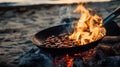 Roasting chestnuts over open fire on beach at sunset Royalty Free Stock Photo