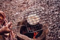 Roasting Khao Kriab or rice flour local snack of Ban Nam Chiao,