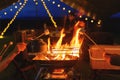 Roasting marshmallows on campfire grill in romantic night camping yard and night light with twilight sky blur background. Dessert Royalty Free Stock Photo