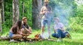 Roasting marshmallows popular group activity around bonfire. Company friends prepare roasted marshmallows snack nature Royalty Free Stock Photo