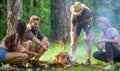 Roasting marshmallows popular group activity around bonfire. Company friends prepare roasted marshmallows snack nature Royalty Free Stock Photo