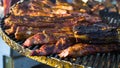 Roasting meat on metal grid over charcoal grill outside Royalty Free Stock Photo