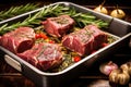 roasting pan with beef roast, fresh rosemary branches, and whole garlic