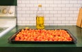 Roasting pan with a Grappoli d`Inverno winter grape tomatoes and a bottle of Italian olive oil Royalty Free Stock Photo