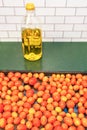 Roasted grape tomatoes and a bottle of Italian olive oil Royalty Free Stock Photo