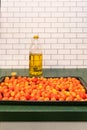 Roasting pan with `a Grappoli d`Inverno` winter grape tomatoes and a bottle of Italian olive oil Royalty Free Stock Photo