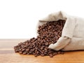 Roated coffee beans spill out of the bag Royalty Free Stock Photo