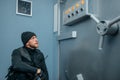 Robber in black uniform sitting at the vault door Royalty Free Stock Photo