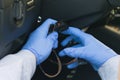 Robber in blue gloves breaks the law, steals a car by hacking into the security system Royalty Free Stock Photo