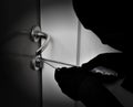 Robber breaking the door lock Royalty Free Stock Photo