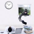 Robber stealing cellphone in office Royalty Free Stock Photo