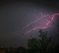 Colorful pink lightning bolt and streaks on a stormy night in Kentucky looking out a window-Natures photography Royalty Free Stock Photo