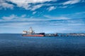 Freighter is loaded with coal mined from the Canadian Rocky Mountains and Western Canada under a deep blue sky.