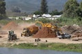 Tractor trailer working on tree shredding site on Breede River.