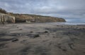 Robin Hood`s Bay, colorful sands on the beach. Royalty Free Stock Photo