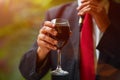 Rabbi holds kiddish cup with wine in front of Groom and Bride