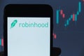 Robinhood logo on smartphone screen, IPO on NASDAQ. Stock price chart seen at background. Moscow 26 March 2021