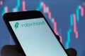 Robinhood logo on smartphone screen, IPO on NASDAQ. Stock price chart seen at background. Moscow 26 March 2021