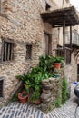 Entrance stairs to an old house with adobe and slate walls with a wooden arch