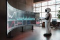 A robot analyst stands before a large curved screen displaying financial market data in a modern office setting. The Royalty Free Stock Photo