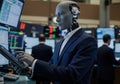 Robot analyzing financial data at stock exchange with businessmen in background