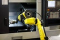 Robot arm is loading detail into CNC lathe machine