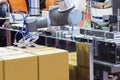 The robot arm transfers carton box  to conveyor line Royalty Free Stock Photo