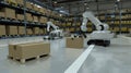 A robot arm working alongside an electric cargo bot as it delivers boxes in the style of modern warehouse creating more Royalty Free Stock Photo