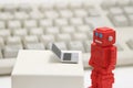 Robot or artificial intelligence and laptop with the keyboard on white background. Royalty Free Stock Photo
