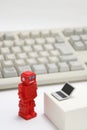 Robot or artificial intelligence and laptop with the keyboard on white background. Royalty Free Stock Photo