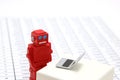 Robot or artificial intelligence and laptop on the number of tables in document. Royalty Free Stock Photo