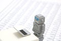 Robot or artificial intelligence and laptop on the number of tables in document. Royalty Free Stock Photo