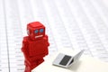 Robot or artificial intelligence and laptop on the number of tables in document. Royalty Free Stock Photo