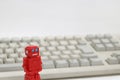 Robots or artificial intelligence and PC keyboard on white background. Royalty Free Stock Photo