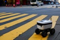 robot courier waiting at pedestrian crossing