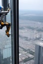 Robot on the Edge: A Daring Feat of Free Climbing on a Glass Tower Royalty Free Stock Photo