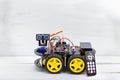 Robot on four wheels and a variety of cables with remote control