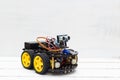 Robot on four yellow wheels on a light background