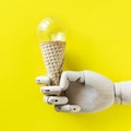 Robot hand holding a light bulb ice cream Royalty Free Stock Photo