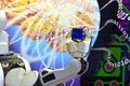 A robot hand holding a Rubik`s Cube with the abstract background