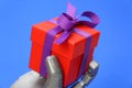 Robot hand holds a gift. Concept - robot congratulates