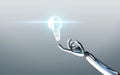 Robot hand with light bulb over gray background Royalty Free Stock Photo