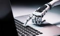 Robot hand pressing computer keyboard enter Royalty Free Stock Photo