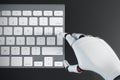 Robot hand typing on a computer keyboard Royalty Free Stock Photo