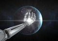 Robot hand with white light in front of globe Royalty Free Stock Photo