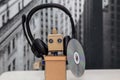 Robot with headphones and holding a disc