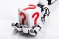 Robot Holding Cubic Block With Question Mark Sign