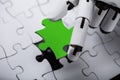 Robot Holding Green Jigsaw Puzzle Royalty Free Stock Photo