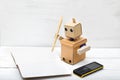 The robot holds the handle of kraft paper and wrote in diaries. Royalty Free Stock Photo