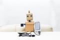 The robot holds a solar battery in its hand with a wire, in the